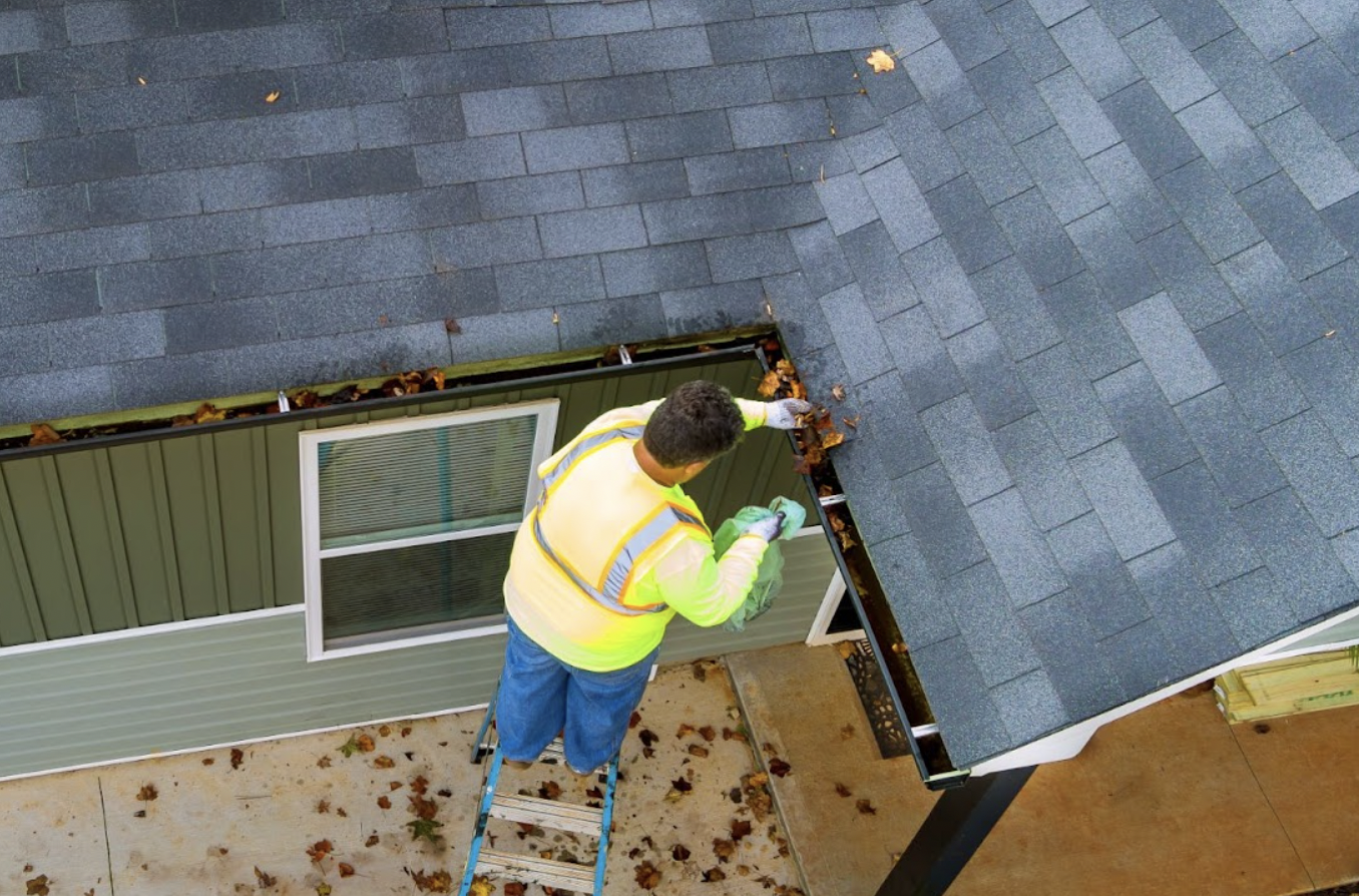 Man doing Roof Maintenance To Ensure Roof Longevity